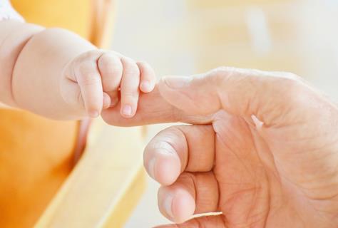 Baby holding a hand jigsaw puzzle