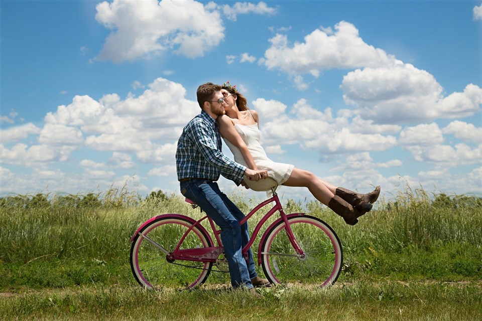 Couple sitting on red bicycle jigsaw puzzle