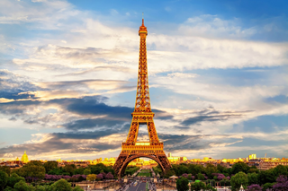 a large tall tower with a clock with Eiffel Tower in the background jigsaw puzzle
