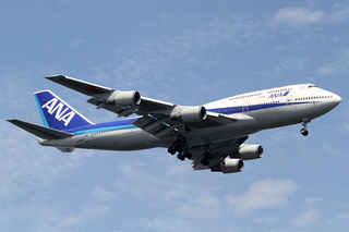a large passenger jet flying through a blue sky jigsaw puzzle