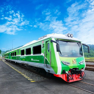 a green train that is sitting on a track jigsaw puzzle