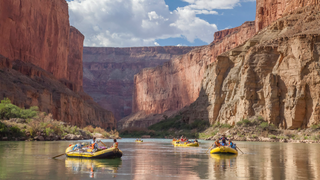 a small boat in a body of water with a mountain in the background jigsaw puzzle