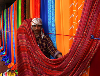a person standing in front of a curtain jigsaw puzzle