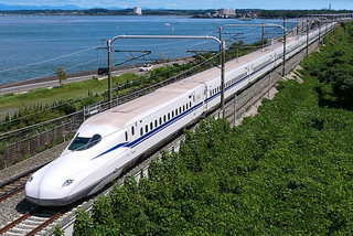 a large long train on a track next to a body of water jigsaw puzzle