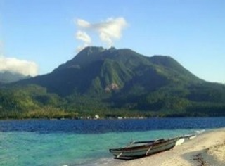 a small boat in a body of water with a mountain in the background jigsaw puzzle