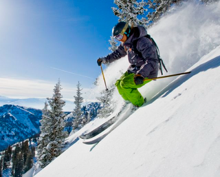 a man skiing down the side of a snow covered slope jigsaw puzzle