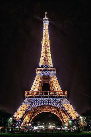 a clock tower lit up at night with Eiffel Tower in the background jigsaw puzzle