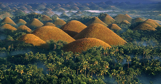 a view of a canyon with Chocolate Hills in the background jigsaw puzzle