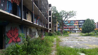 a building with graffiti on the side of the street jigsaw puzzle