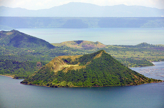 a view of a large body of water with Taal Volcano in the background jigsaw puzzle
