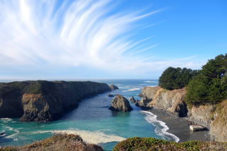 a rocky island in the middle of a body of water jigsaw puzzle