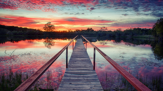 a train crossing a bridge over a body of water jigsaw puzzle