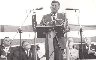 John F. Kennedy standing on a boat posing for the camera jigsaw puzzle