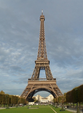 a large clock tower in the background with Eiffel Tower in the background jigsaw puzzle