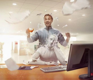 a person sitting at a table with a laptop and smiling at the camera jigsaw puzzle