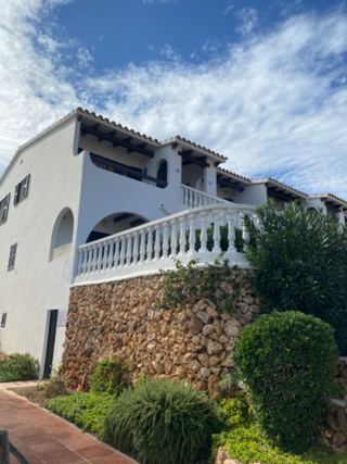 a house with bushes in front of a building jigsaw puzzle
