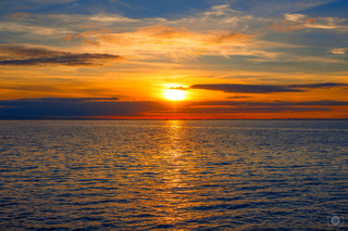 a sunset over a body of water jigsaw puzzle