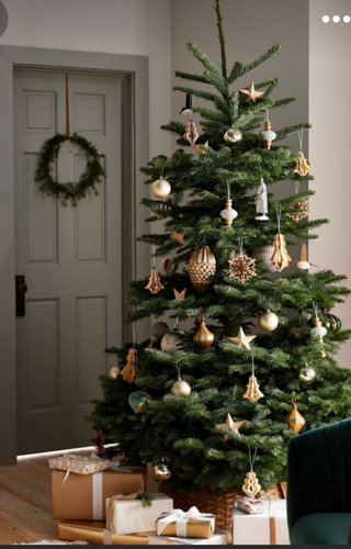a vase of flowers on a table next to a christmas tree jigsaw puzzle