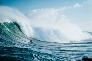 a man riding a wave on a surfboard in the ocean jigsaw puzzle
