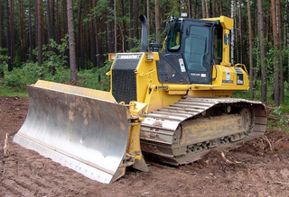 a tractor parked in the dirt jigsaw puzzle