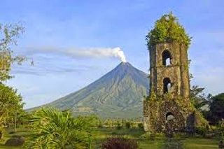 a view of a church with Mayon Volcano in the background jigsaw puzzle